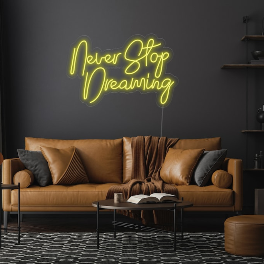 Never Stop Dreaming LED neon sign by Neon.Shop glowing on a modern interior wall as inspirational neon wall decor