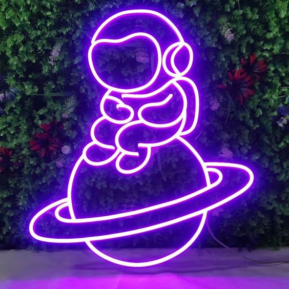 Baby Astronaut UV Art LED neon sign glowing on bedroom wall by Neon.Shop