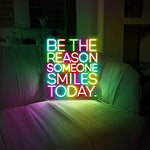 Be The Reason Someone Smiles Today neon sign glowing in bright LED colors by Neon.Shop
