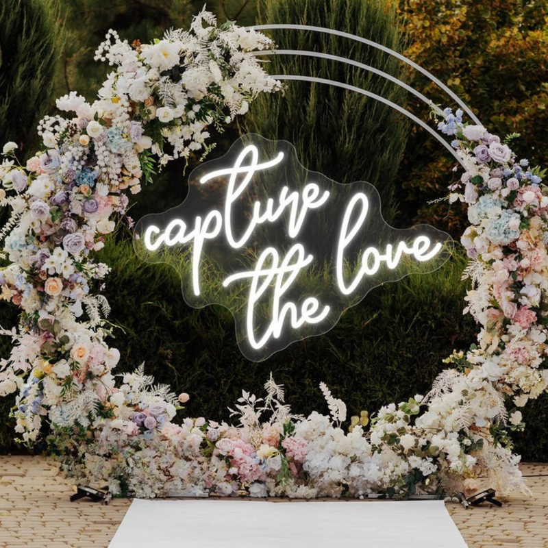 Capture the Love wedding LED neon sign glowing on photo booth backdrop – Neon.Shop