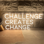 Challenges Creates Change neon sign glowing in bright LED colors by Neon.Shop