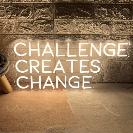 Challenges Creates Change neon sign glowing in bright LED colors by Neon.Shop