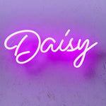 DAISY Name LED Neon Sign by Neon.Shop glowing brightly, custom LED name light for bedroom décor, nurseries, salons, parties, and personalized home styling.