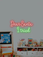 Dear Santa, I Tried Merry Christmas Neon Sign by Neon.Shop featuring playful glowing lettering for holiday décor.