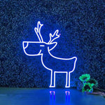 Deer Merry Christmas Neon Sign by Neon.Shop glowing in warm LED light on a festive holiday backdrop.