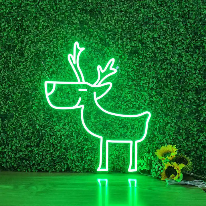 Deer Merry Christmas Neon Sign by Neon.Shop glowing in warm LED light on a festive holiday backdrop.