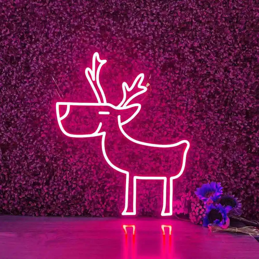 Deer Merry Christmas Neon Sign by Neon.Shop glowing in warm LED light on a festive holiday backdrop.
