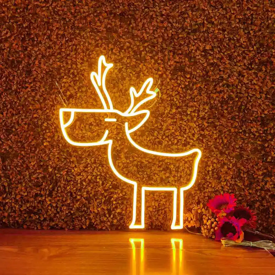 Deer Merry Christmas Neon Sign by Neon.Shop glowing in warm LED light on a festive holiday backdrop.