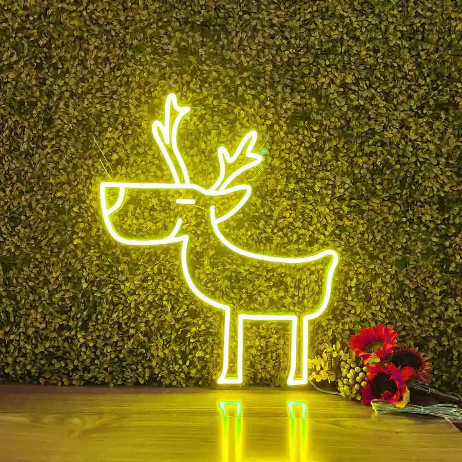 Deer Merry Christmas Neon Sign by Neon.Shop glowing in warm LED light on a festive holiday backdrop.