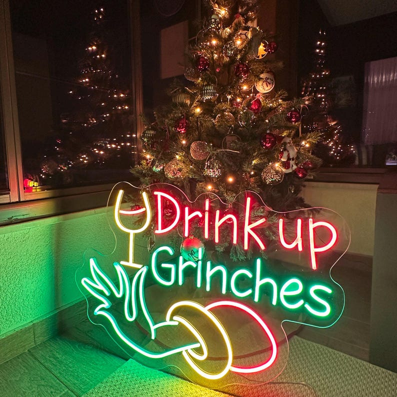 Drink Up Merry Christmas LED neon sign glowing in festive colors by Neon.Shop.