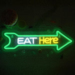 Eat Here LED neon sign by Neon.Shop mounted outside a restaurant to attract foot traffic