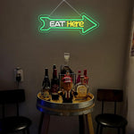 Eat Here LED neon sign by Neon.Shop mounted outside a restaurant to attract foot traffic