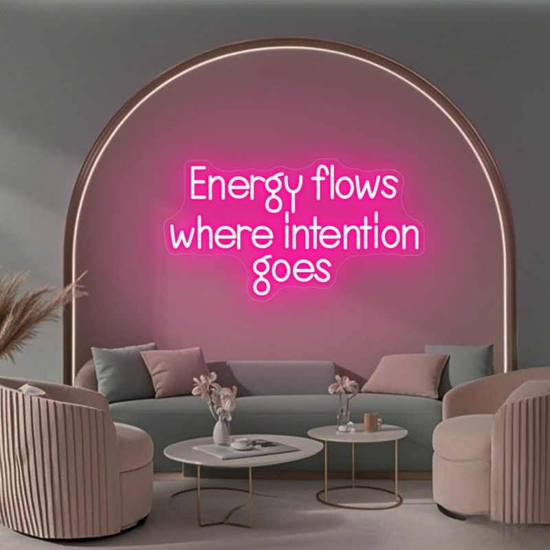 Energy Flows Where Intention Goes” neon sign glowing on a wall, motivational quote décor for office, studio, or home by Neon.Shop.