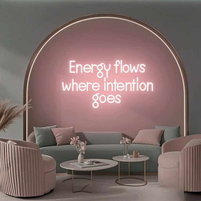 Energy Flows Where Intention Goes” neon sign glowing on a wall, motivational quote décor for office, studio, or home by Neon.Shop.