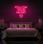 Follow Your Heart” neon sign glowing on a wall, motivational quote décor for bedroom or office by Neon.Shop.