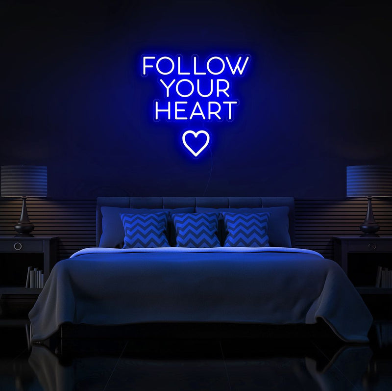 Follow Your Heart” neon sign glowing on a wall, motivational quote décor for bedroom or office by Neon.Shop.