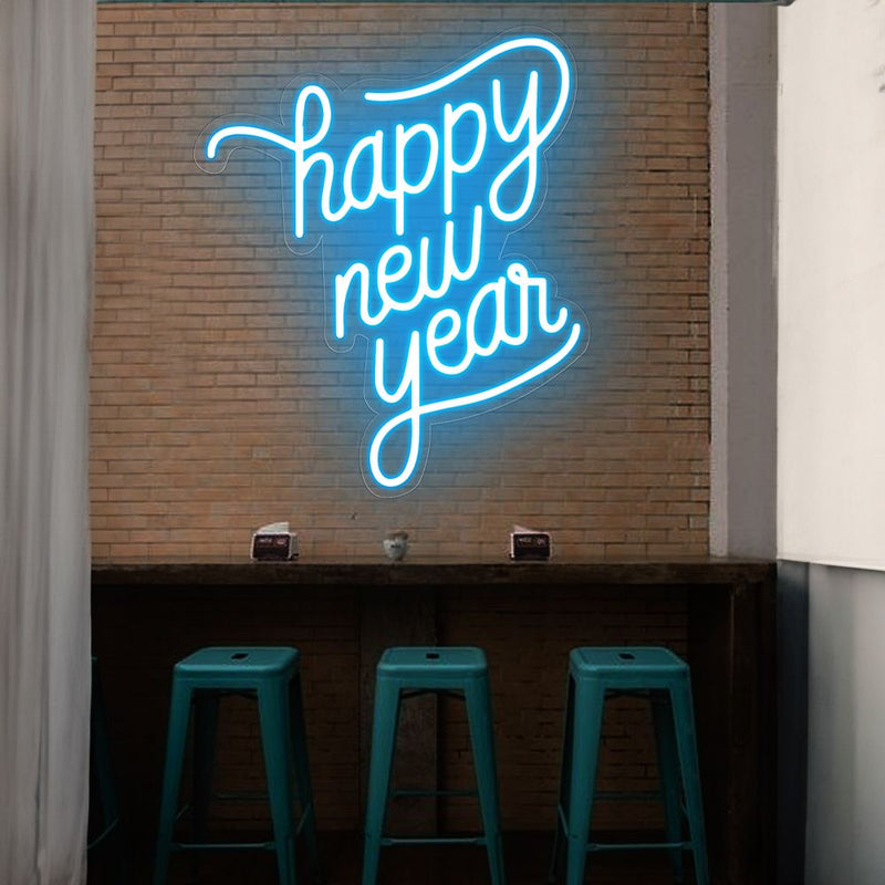 Bright Happy New Year LED neon sign in modern script font, glowing against a dark brick wall by Neon.Shop.