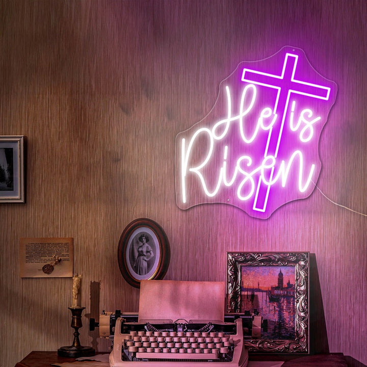 He Is Risen neon wall sign featuring glowing LED lettering representing the resurrection message of Easter by Neon.Shop