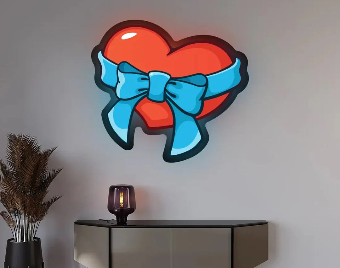 Heart With Ribbon Bow Illuminated Valentine's Day Neon Sign by manhattanneons.com – A sweet and glowing heart tied with love.