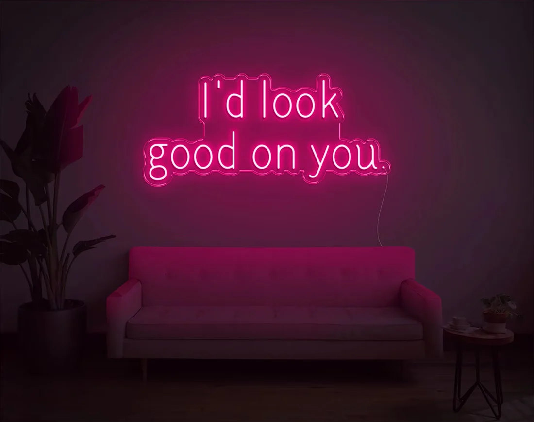 I’d Look Good On You” Valentine’s Day LED neon sign glowing in playful pink and red tones, perfect for romantic décor by Neon.Shop
