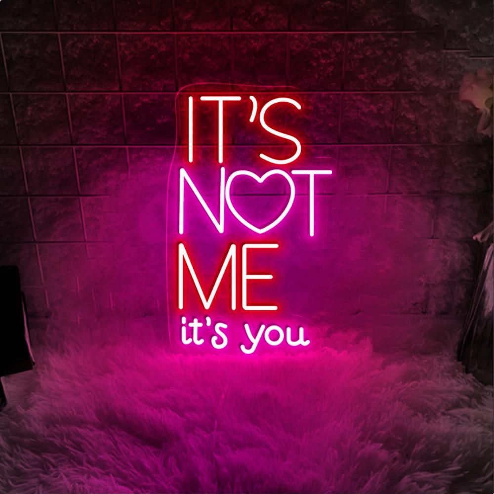 It’s Not Me It’s You neon sign displayed in bar or party setup by Neon.Shop