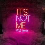 It’s Not Me It’s You neon sign displayed in bar or party setup by Neon.Shop