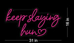 Keep Slaying Hun’ LED neon sign glowing brightly, ideal for beauty salons, glam rooms, and empowering home décor by Neon.Shop
