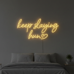 Keep Slaying Hun’ LED neon sign glowing brightly, ideal for beauty salons, glam rooms, and empowering home décor by Neon.Shop