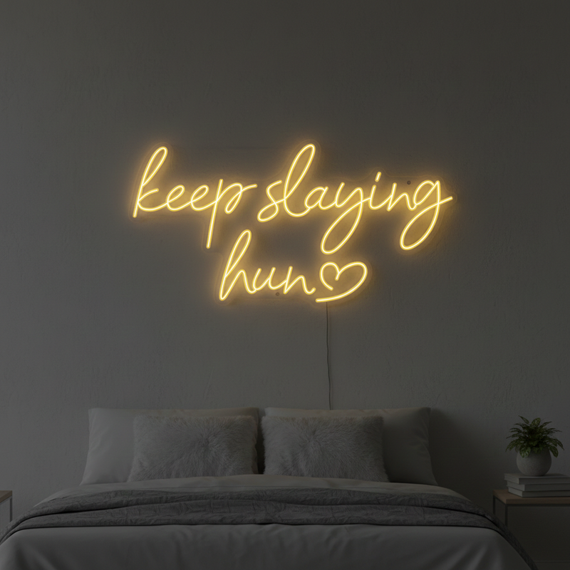 Keep Slaying Hun’ LED neon sign glowing brightly, ideal for beauty salons, glam rooms, and empowering home décor by Neon.Shop