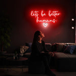 Let’s Be Better Humans neon sign glowing in bright LED colors by Neon.Shop
