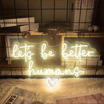 Let’s Be Better Humans neon sign glowing in bright LED colors by Neon.Shop