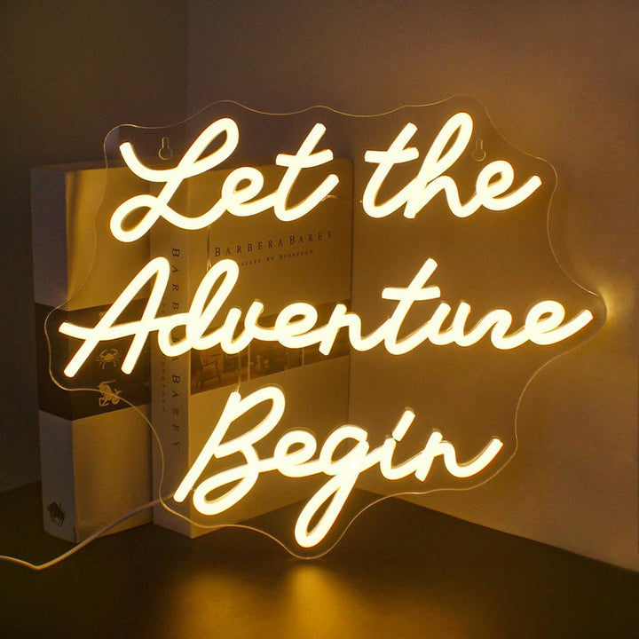 Let the Adventure Begin wedding LED neon sign glowing on backdrop – Neon.Shop