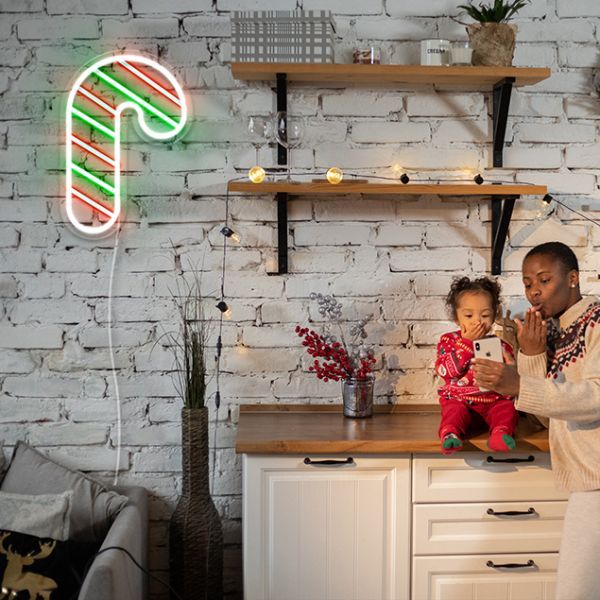 Light Up Candy Cane Merry Christmas Neon Sign by Neon.Shop glowing in LED light with candy cane and festive lettering design.