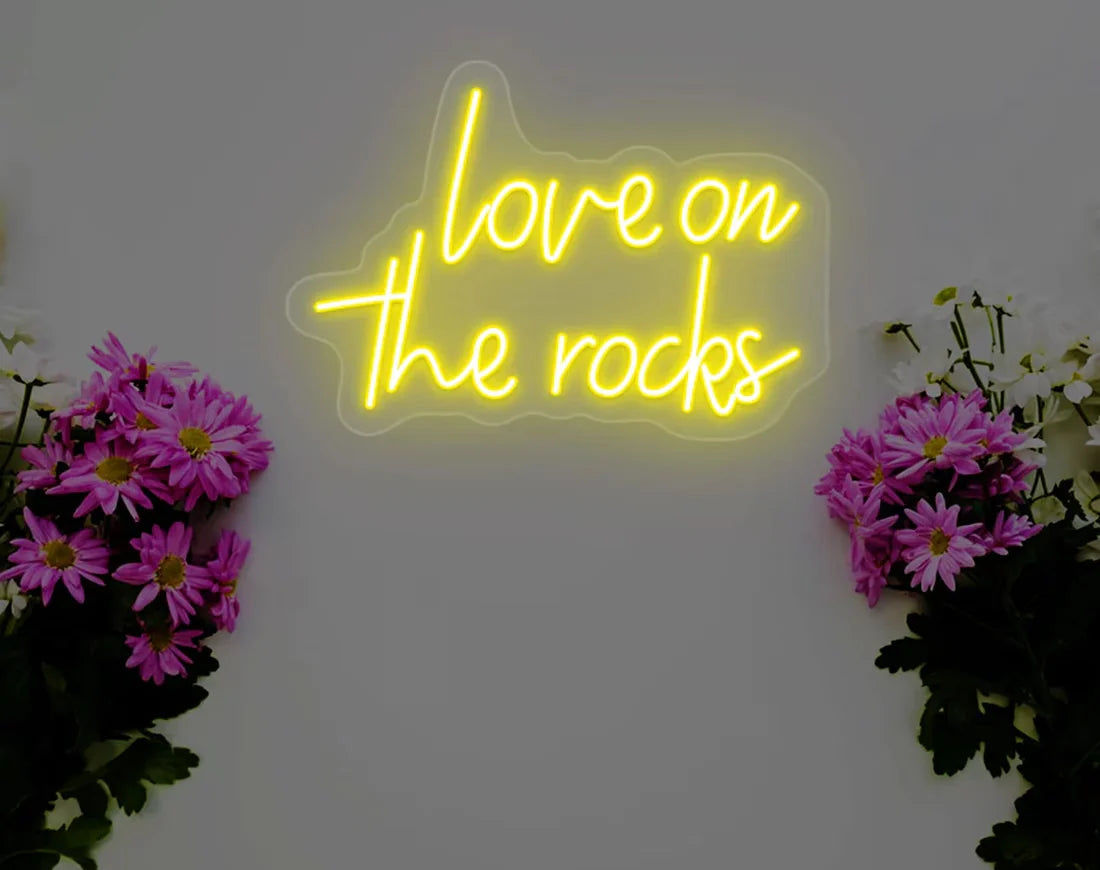 Love On The Rocks Valentine’s Day LED neon sign glowing in bold romantic tones, perfect for bedroom décor, home bars, Valentine’s gifts, and playful love-themed spaces by Neon.Shop.