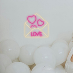 Love Envelope Valentine’s Day Neon Sign glowing on wall for romantic décor by Neon.Shop