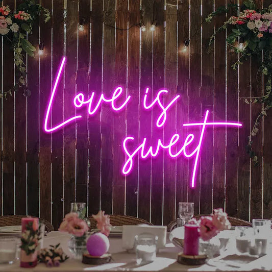 Love Is Sweet Valentine’s Day neon sign glowing in warm LED lights, romantic wall décor by Neon.Shop