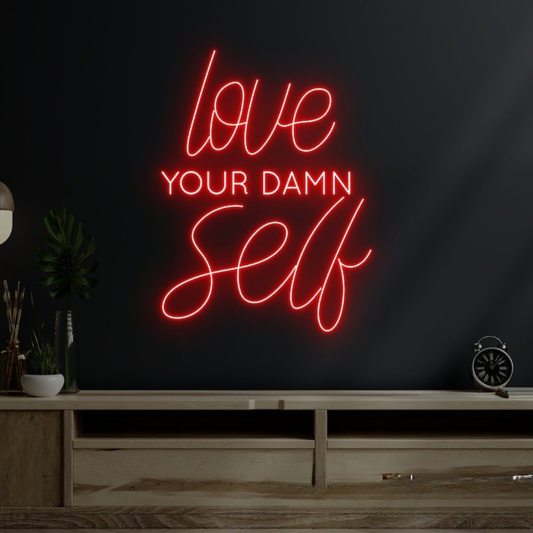 Love Your Damn Self LED neon sign by Neon.Shop glowing on a modern wall as bold and inspirational neon décor