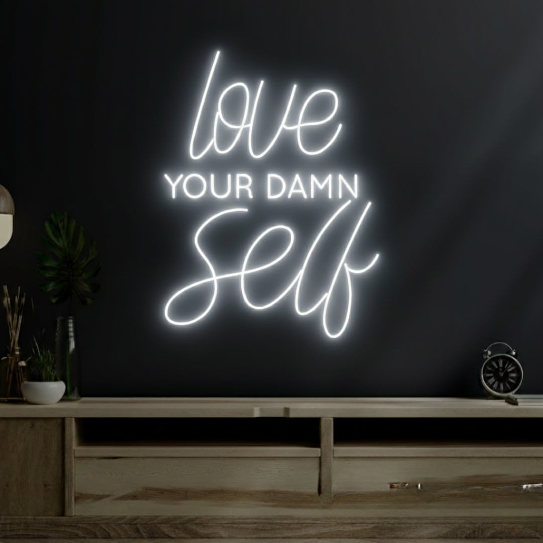 Love Your Damn Self LED neon sign by Neon.Shop glowing on a modern wall as bold and inspirational neon décor