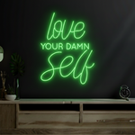 Love Your Damn Self LED neon sign by Neon.Shop glowing on a modern wall as bold and inspirational neon décor