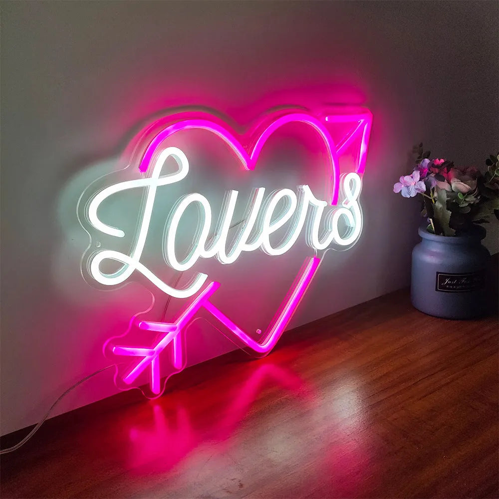 Lovers with arrow inside the heart Valentine’s Day LED neon sign glowing in romantic pink tones by Neon.Shop