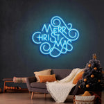 Merry Christmas Typo Neon Sign by Neon.Shop glowing in quirky vibrant LED colors for festive décor.
