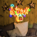 Multicolor Reindeer Merry Christmas LED neon sign glowing in festive colors by Neon.Shop.