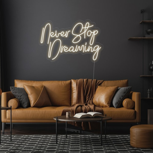 Never Stop Dreaming LED neon sign by Neon.Shop glowing on a modern interior wall as inspirational neon wall decor