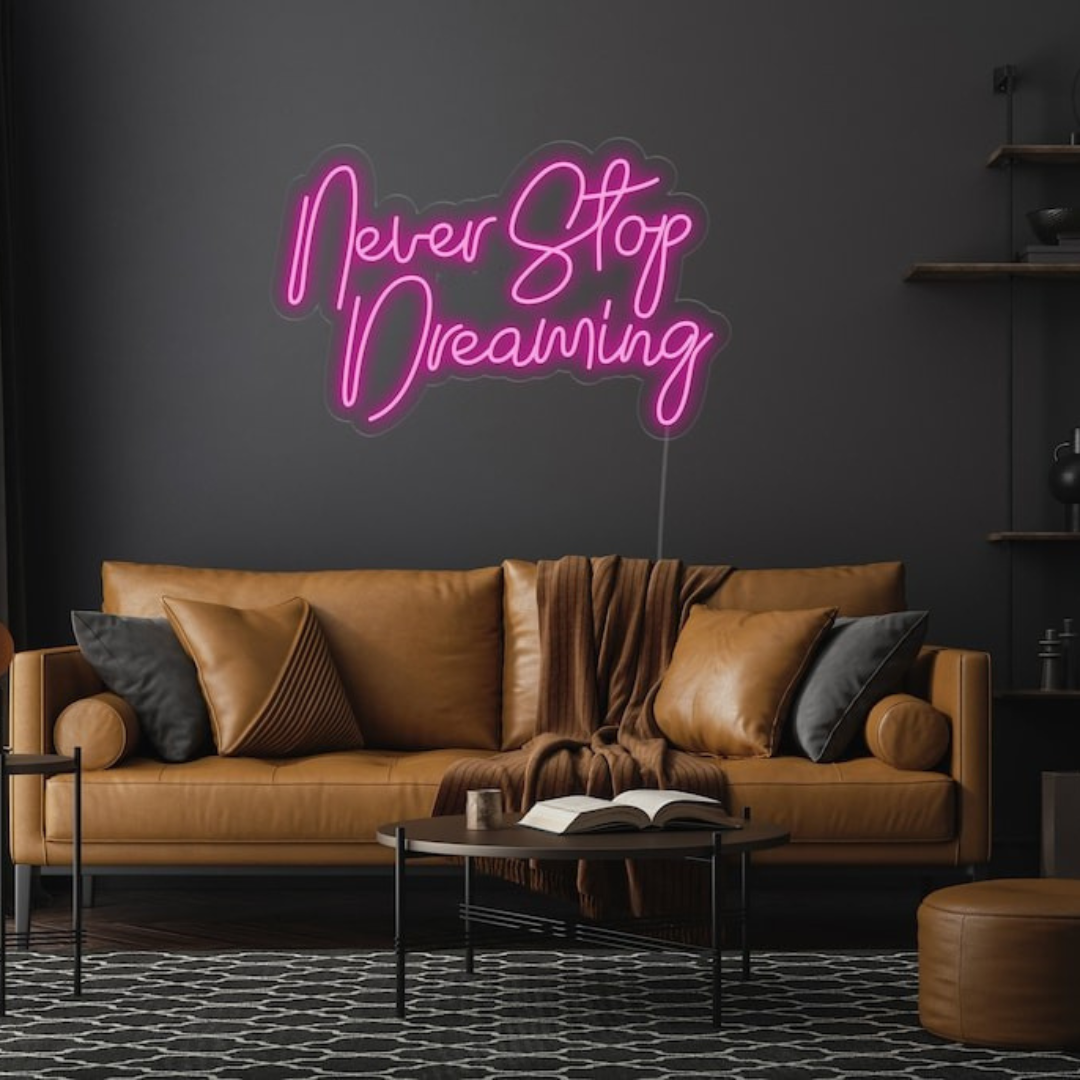 Never Stop Dreaming LED neon sign by Neon.Shop glowing on a modern interior wall as inspirational neon wall decor