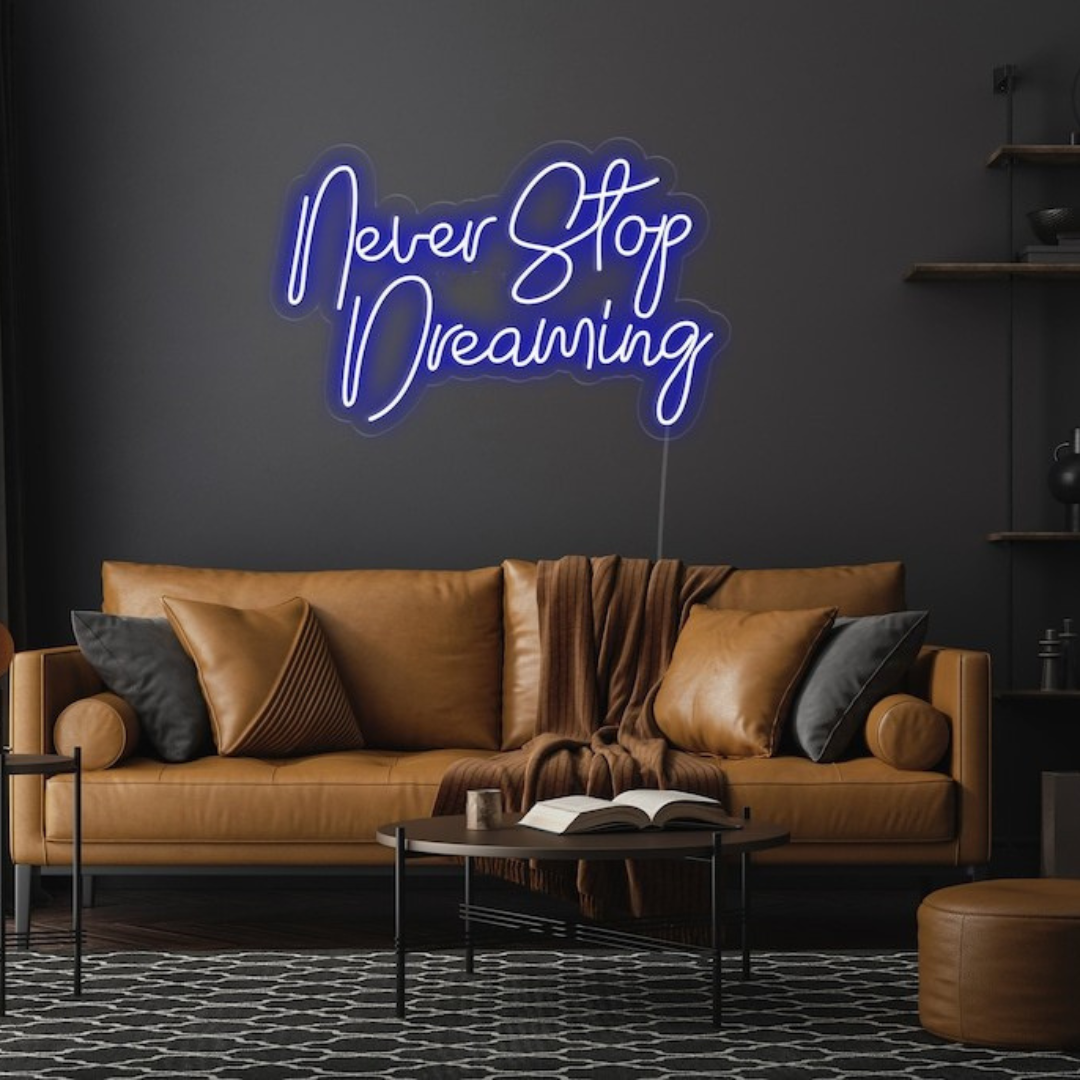 Never Stop Dreaming LED neon sign by Neon.Shop glowing on a modern interior wall as inspirational neon wall decor