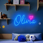OLIVIA LED Neon Name Sign by Neon.Shop adding vibrant LED glow to bedrooms, home offices, and living spaces.