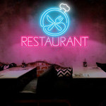 Restaurant Business Neon Sign by Neon.Shop glowing brightly above the entrance of a dining establishment, attracting diners day and night