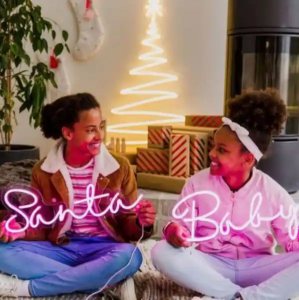 Santa Baby Merry Christmas Neon Sign by Neon.Shop glowing in LED light with playful holiday lettering design.
