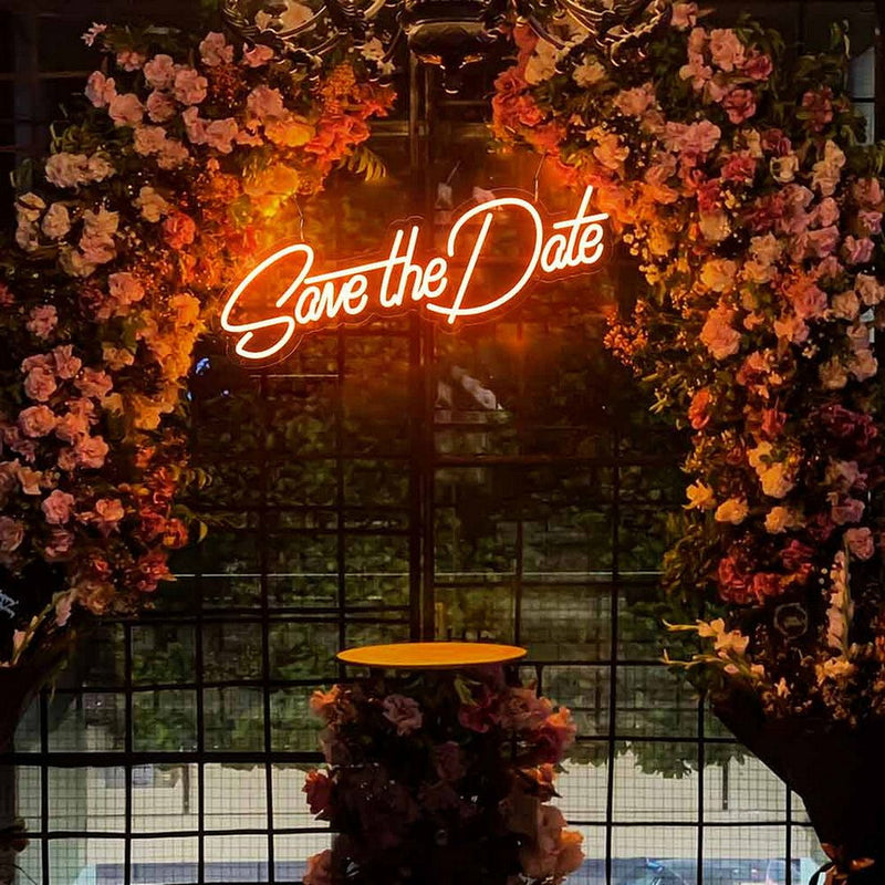 Save The Date wedding LED neon sign glowing on engagement backdrop – Neon.Shop