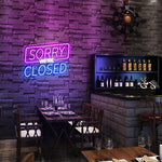 Sorry We Are Closed Business Neon Sign by Neon.Shop glowing above a shop entrance, letting customers know the business is closed